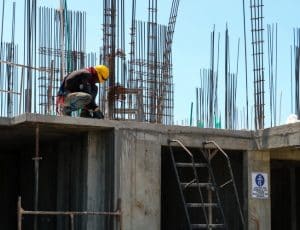 Photographie sur laquelle on voit un ouvrier travailler sur un chantier en cours.